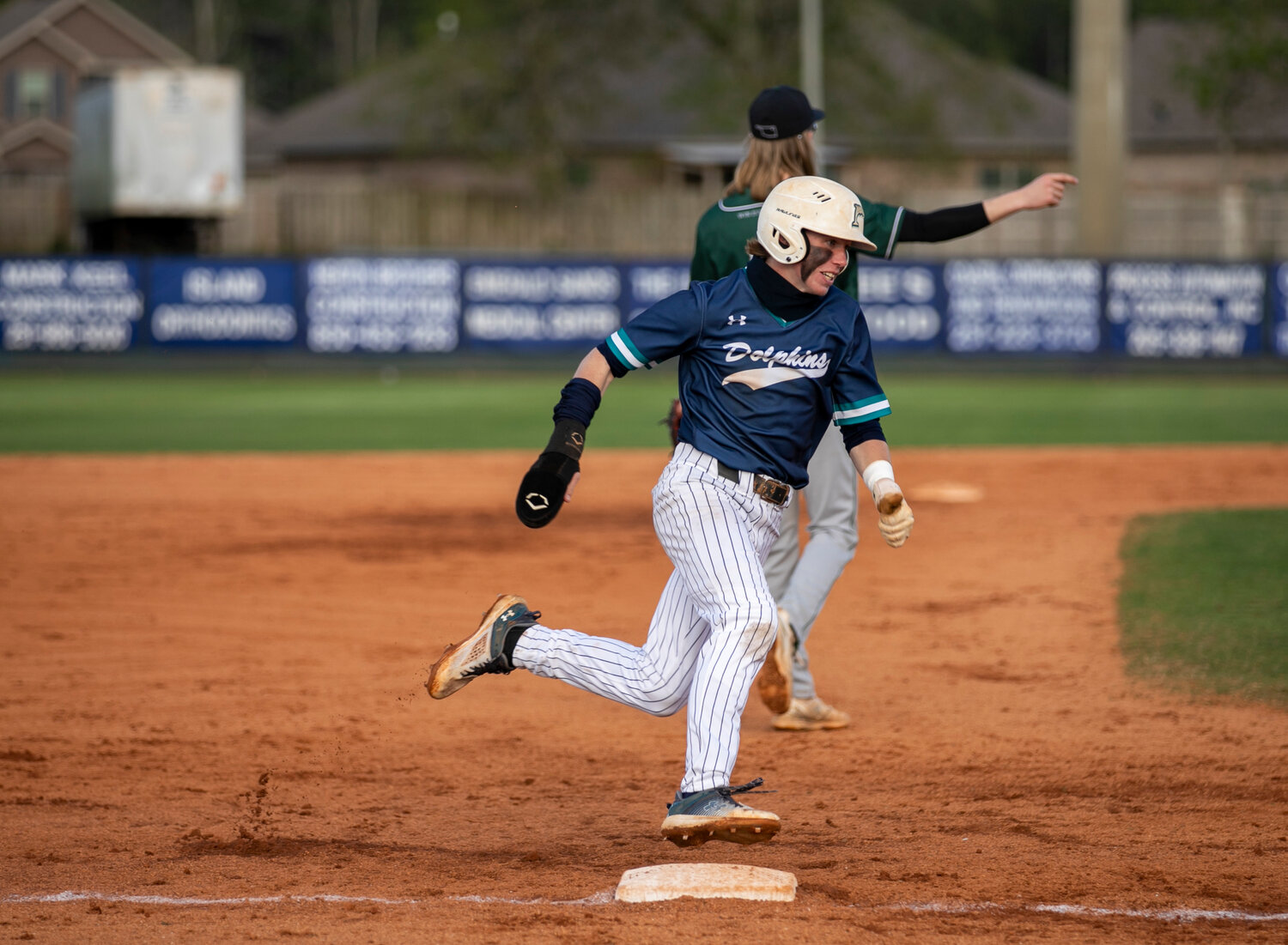 Dolphin junior Joseph Stephens rounds third to head home and score a run against the Muskogee Roughers from Oklahoma during the Gulf Coast Classic tournament on March 13. Stephens scored 43 runs on the season to help Gulf Shores claim a third straight area crown.