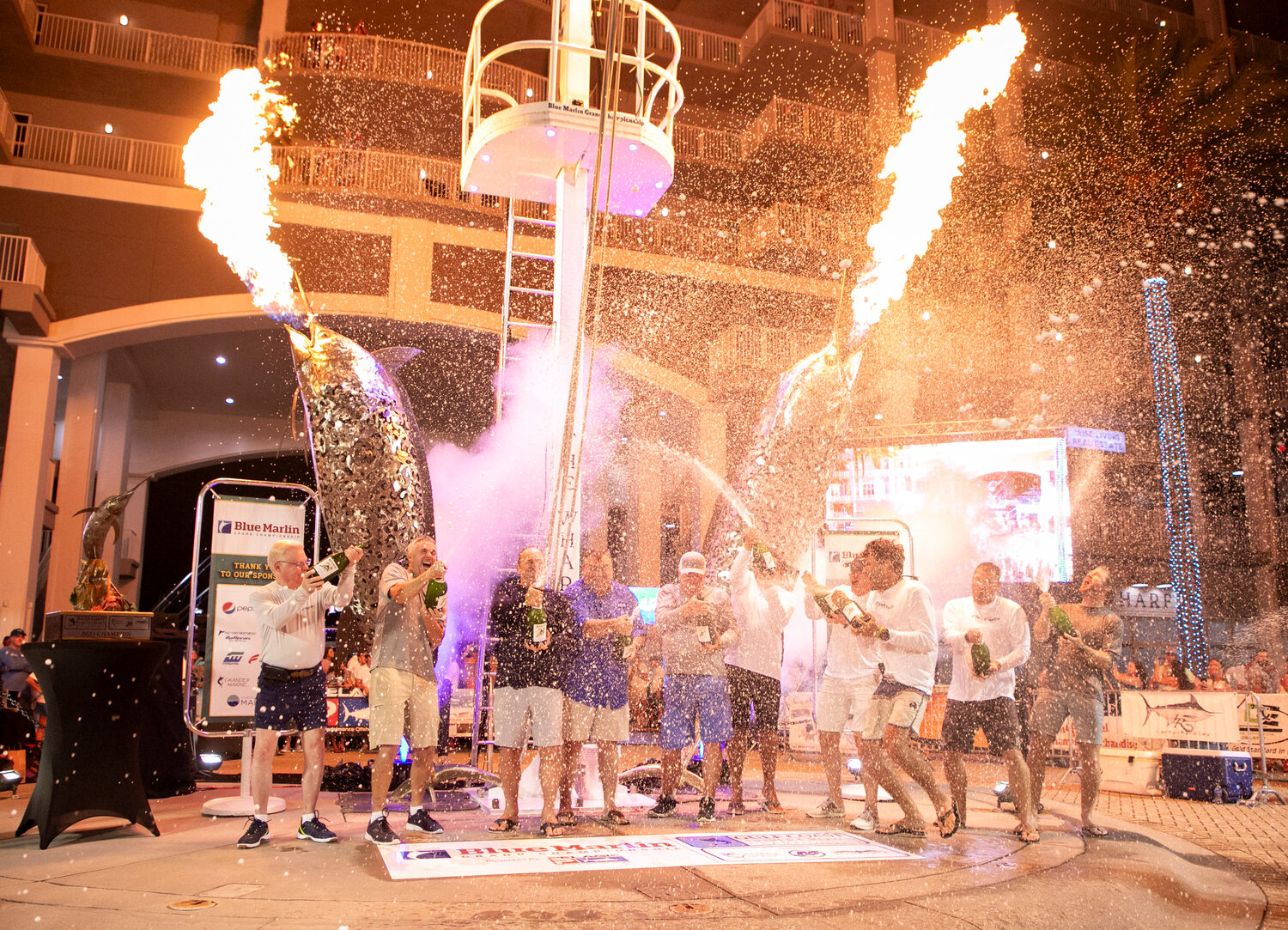 A Work of Art sprays champagne on Marlin Circle at The Wharf on Saturday, July 15, after winning the Blue Marlin Grand Championship with a 597.4-pound, 121-inch haul.