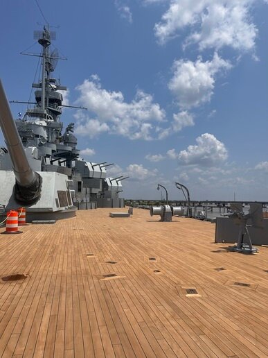 After over 80 years of wear, the WWII battleship deck required replacement. Beginning in 2022, Battleship Memorial Park’s three-year teak deck replacement project was underway. Since then, crews from Teak Decking Systems and Youngblood Barrett Construction have completed three of five phases.