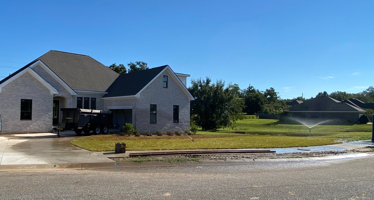 A newly built home in Fairhope with freshly laid sod waters the lawn even though it is prohibited under the phase three water emergency.