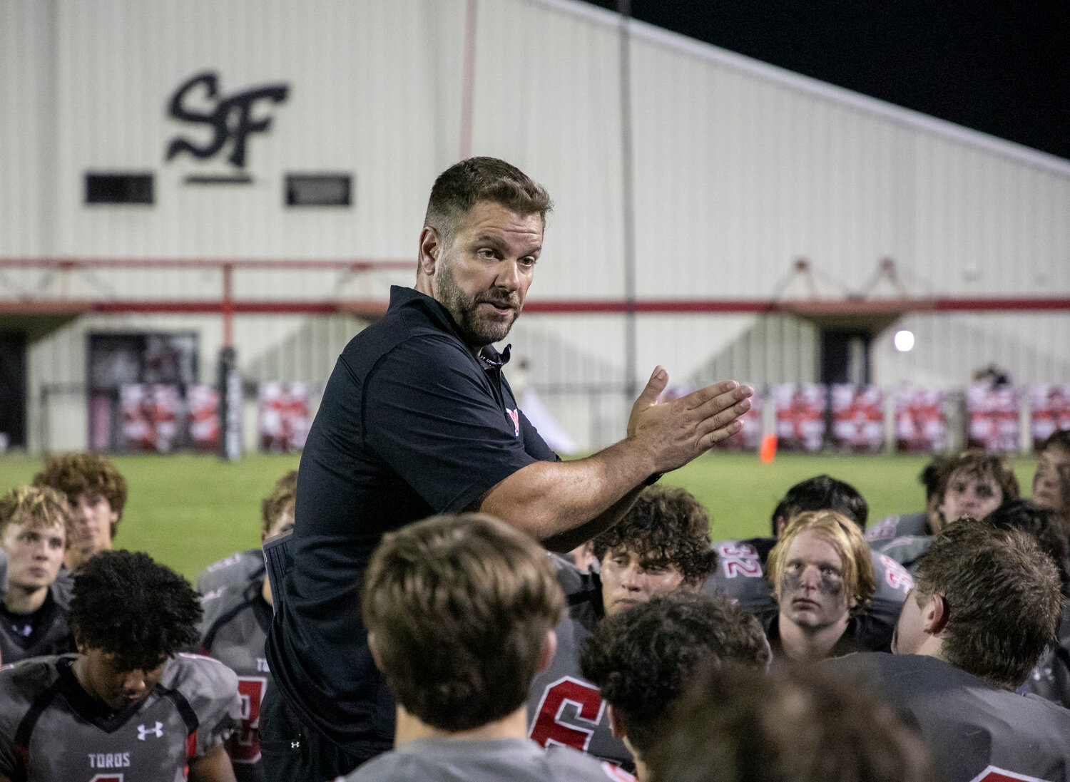 Toro head football coach Chase Smith meets with his Spanish Fort team after the preseason jamboree with the St. Michael Catholic Cardinals at home Thursday, Aug. 17.