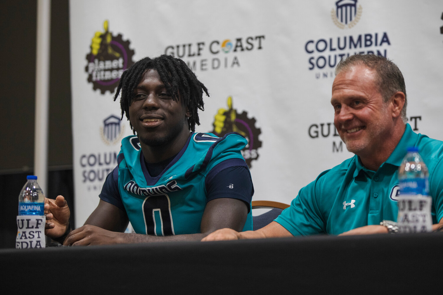 Gulf Shores senior Kingston Lowe and head coach Mark Hudspeth react to a question during the second-annual Gulf Coast Media Day on July 27. The Dolphins are set to kick off the regular season against St. Michael on Thursday at home.