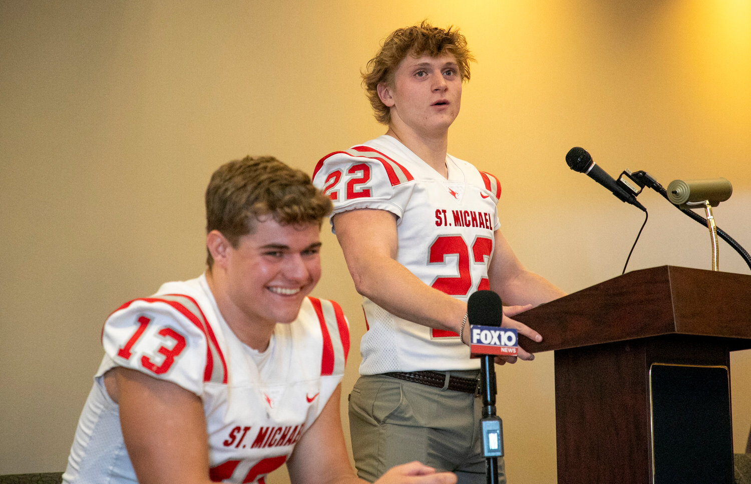 Cardinal seniors Martin Corte (22) and Zach Taylor (13) react to a question at Baldwin County Media Days in Daphne on July 31 where local teams previewed their upcoming seasons. Corte is one of the upperclassmen leaders on a fairly young St. Michael squad this season.