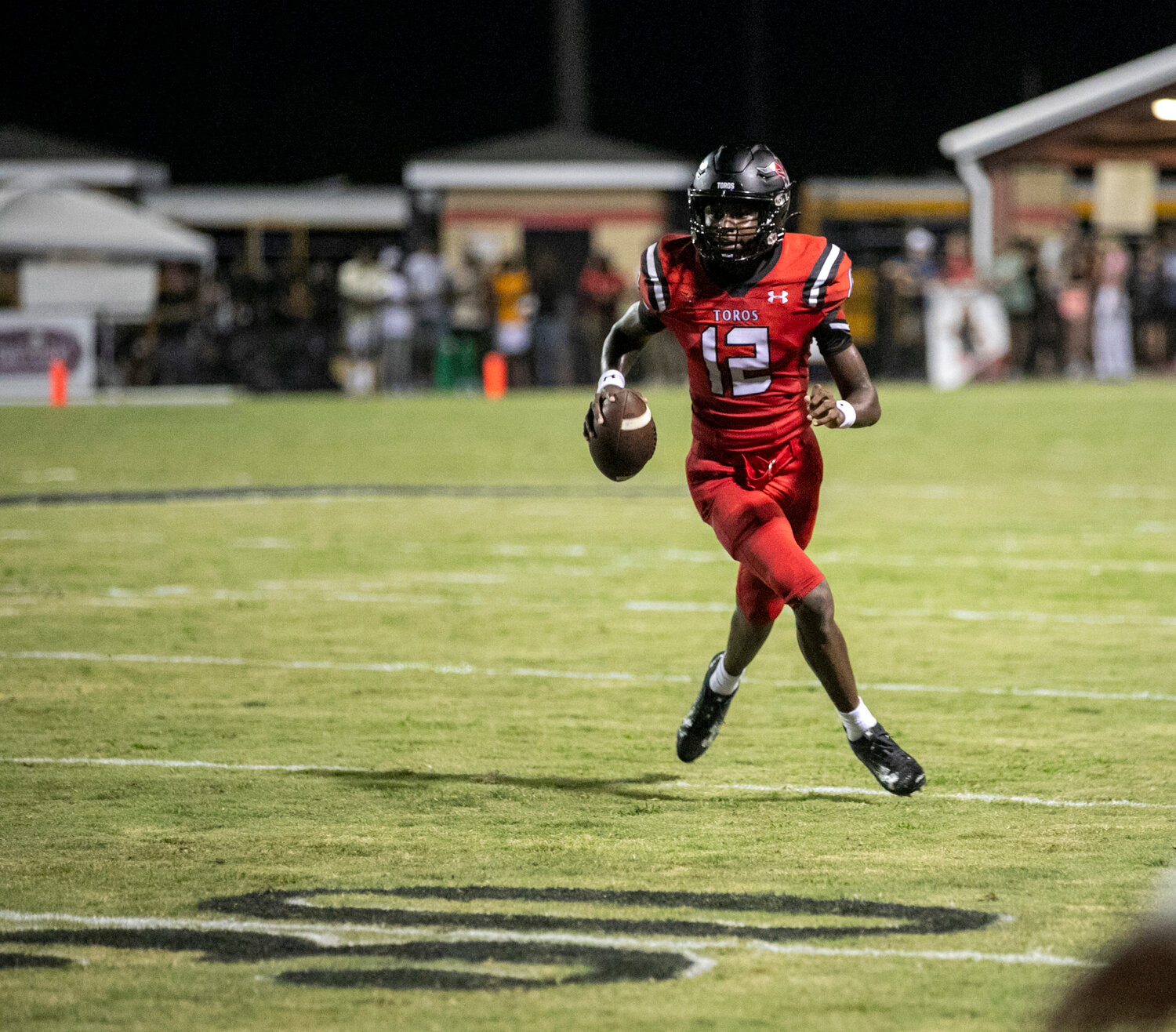 Spanish Fort quarterback Aaden Shamburger scrambles near the sideline during his first start as a Toro on Thursday, Aug. 24, at home against the Fairhope Pirates. Shamburger collected his first touchdown for Spanish Fort in the first quarter of the regular-season opener.
