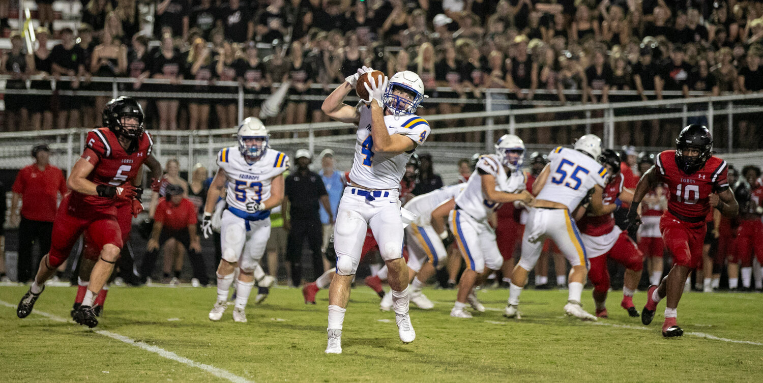 Pirate senior and Harvard commit Sanders Daniell catches a pass and looks up field with Toro defenders Cole McConathy (6, a Louisville commit) and Sterling Dixon (10, an Alabama commit) bearing down on him during Thursday’s season-opening game in Spanish Fort.