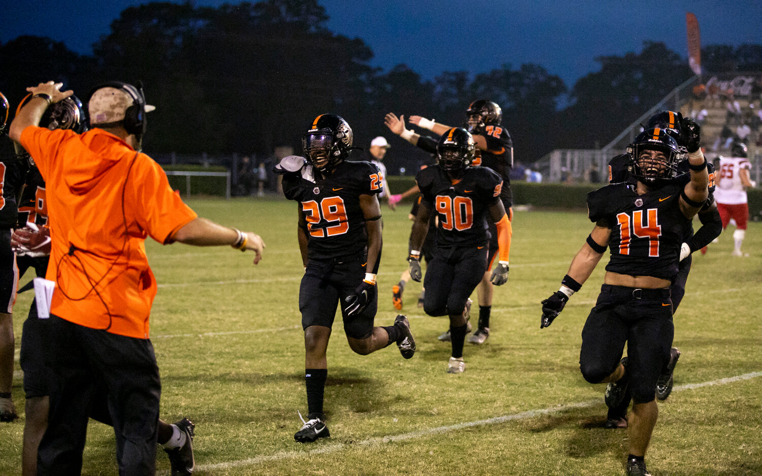 The Baldwin County defense, including PJ Cook (14) and Kendreas Nelson (90), runs to its sideline to celebrate Malachi Stevens’ (29) interception in the first half of the Tigers’ region contest against the Spanish Fort Toros on Mitchell Field at Bay Minette’s Lyle Underwood Stadium on Friday, Sept. 8. It was one of four takeaways earned by Baldwin County in its 14-13 loss.