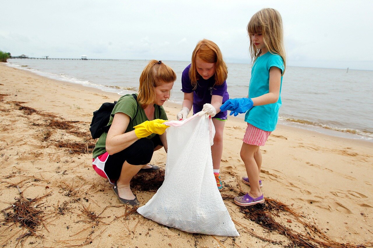 Volunteers from Girl Scout Troop 8572, l-r, Jeannette Hill, Lauren Godwin, 8, and Marie Hill, 7, collect debris at the public beach as they participate in the 26th Alabama Coastal Cleanup on Saturday, Sept. 21, 2013, in Fairhope, Ala. The cleanup covers 27 sites in Mobile and Baldwin Counties. (Mike Kittrell/mkittrell@al.com)