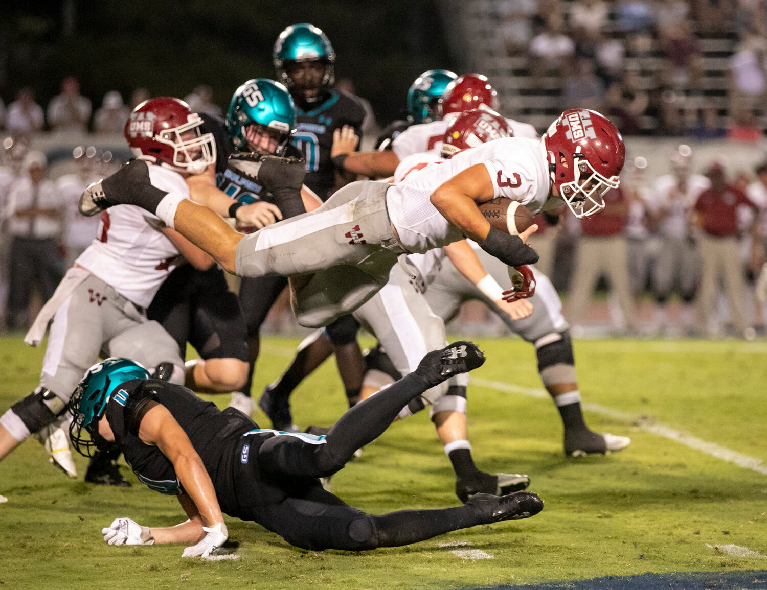 Gulf Shores junior Carter Byrd (4) upends UMS-Wright senior Jake Jaye (3) in the second half of region action at the Gulf Shores Sportsplex on Friday, Sept. 15. Byrd and the Dolphin defense registered a 17-0 shutout of the sixth-ranked Bulldog offense.