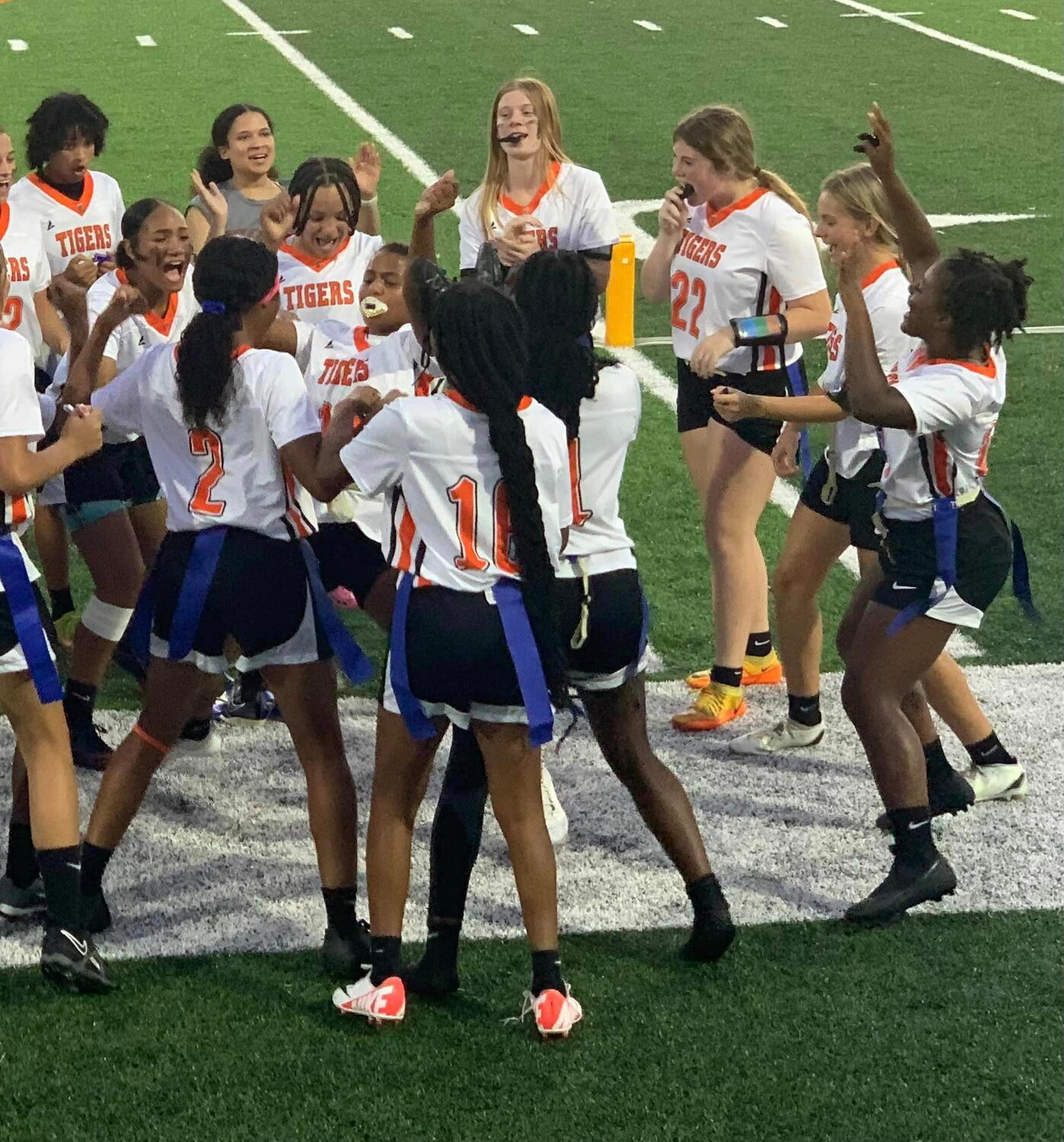 The Baldwin County Tigers celebrate on the sideline during their inaugural flag football game against the LeFlore Rattlers in Mobile on Tuesday, Sept. 19. Baldwin County is playing in its first flag football season after the AHSAA launched the sport with a pilot season this year before aligning it for championship play in 2024.