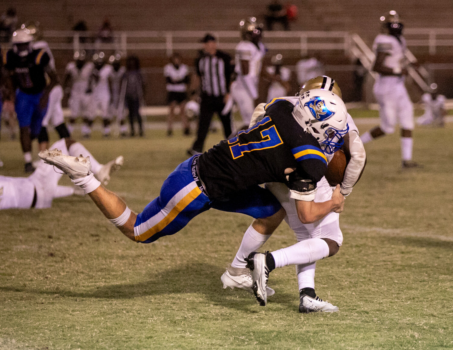 Pirate senior Dixon Davis pulls down Warrior junior Terrance Gray during the second half of Friday’s Class 7A Region 1 game between Fairhope and Davidson on W.C. Majors Field. The Warriors went on to earn a 42-10 victory.