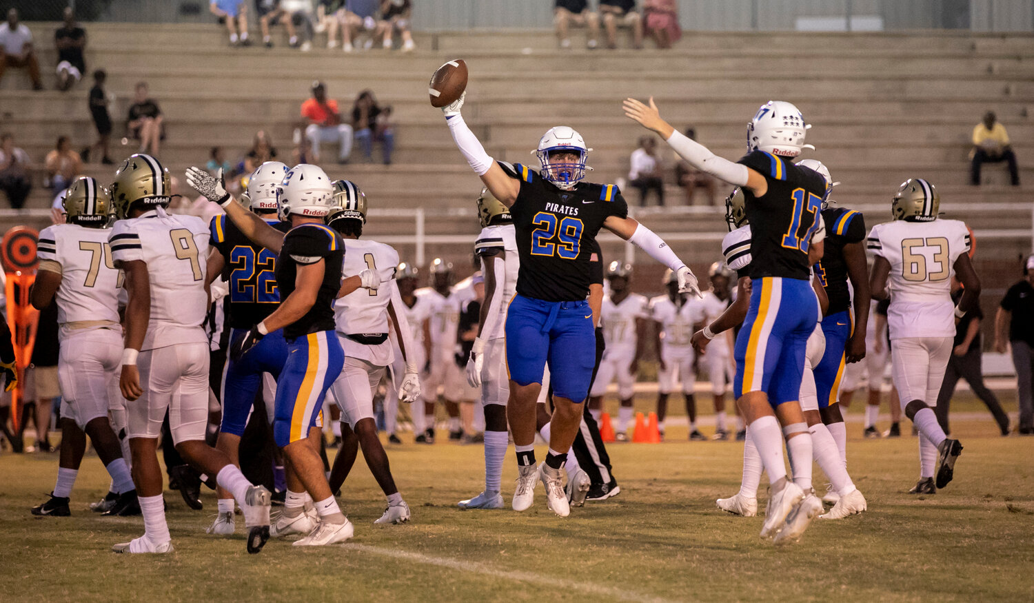 Rock Gearheart (29), Dixon Davis (17), Dallas Boothe (2) and the Fairhope defense celebrate a first-quarter fumble recovery during the Pirates’ region battle with Davidson Friday night at home. The Warriors went on to record a 42-10 win to move to 2-2 in the standings.