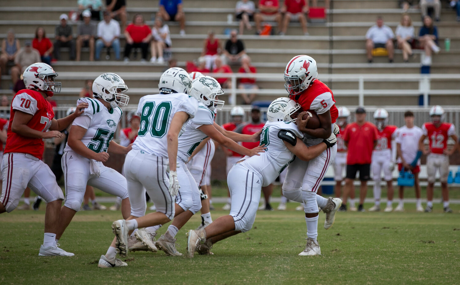 Senior Peyton Loftis (52) and the Bayshore Christian defense rally for a first-quarter stop during Monday’s JV game against the St. Michael Cardinals at Fairhope Municipal Stadium. St. Michael went on to earn a 24-0 win to drop the Eagles to 1-1 in their first season in program history.
