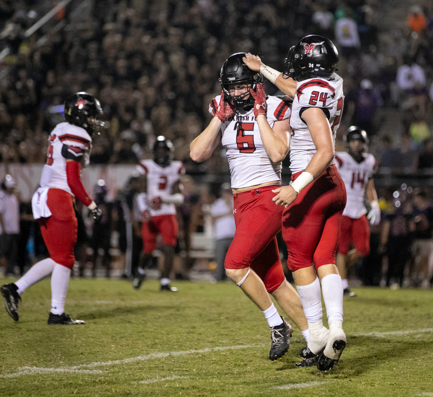 Spanish Fort’s Cole McConathy (6) and Newton Garnder (24) celebrate a fourth-quarter stop of the Daphne offense during the rivalry game between the Toros and Trojans at Jubilee Stadium Friday night. Spanish Fort used a second-half shutout to earn a 35-27, comeback victory.