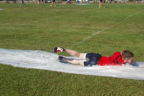 Trying to beat the heat, cadets of AL-935 participate in slip-and-slide kickball.