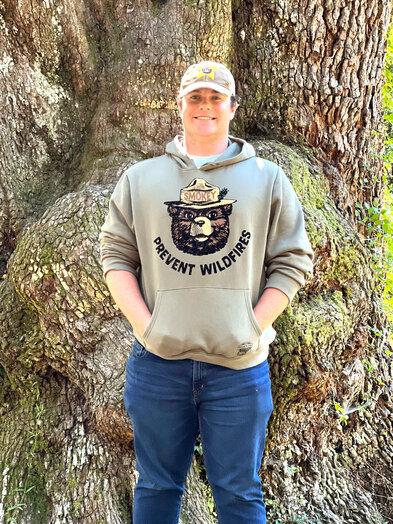 Fairhope High School Senior Gabriel Hunter stands in front of Jackson's Oak in Daphne. Hunter earned his Eagle Scout Award by leading a 350-hour project revitalizing the gravel trail around the storied tree.