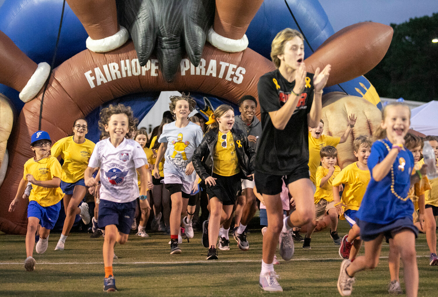 The attendees of the 10th-annual Spina Bidia Awareness Game took the spotlight as they ran out of the Pirate inflatable onto W.C. Majors Field at Fairhope Municipal Stadium on Friday, Oct. 13. The event celebrated its tin anniversary before the Pirates’ game against the Daphne Trojans.