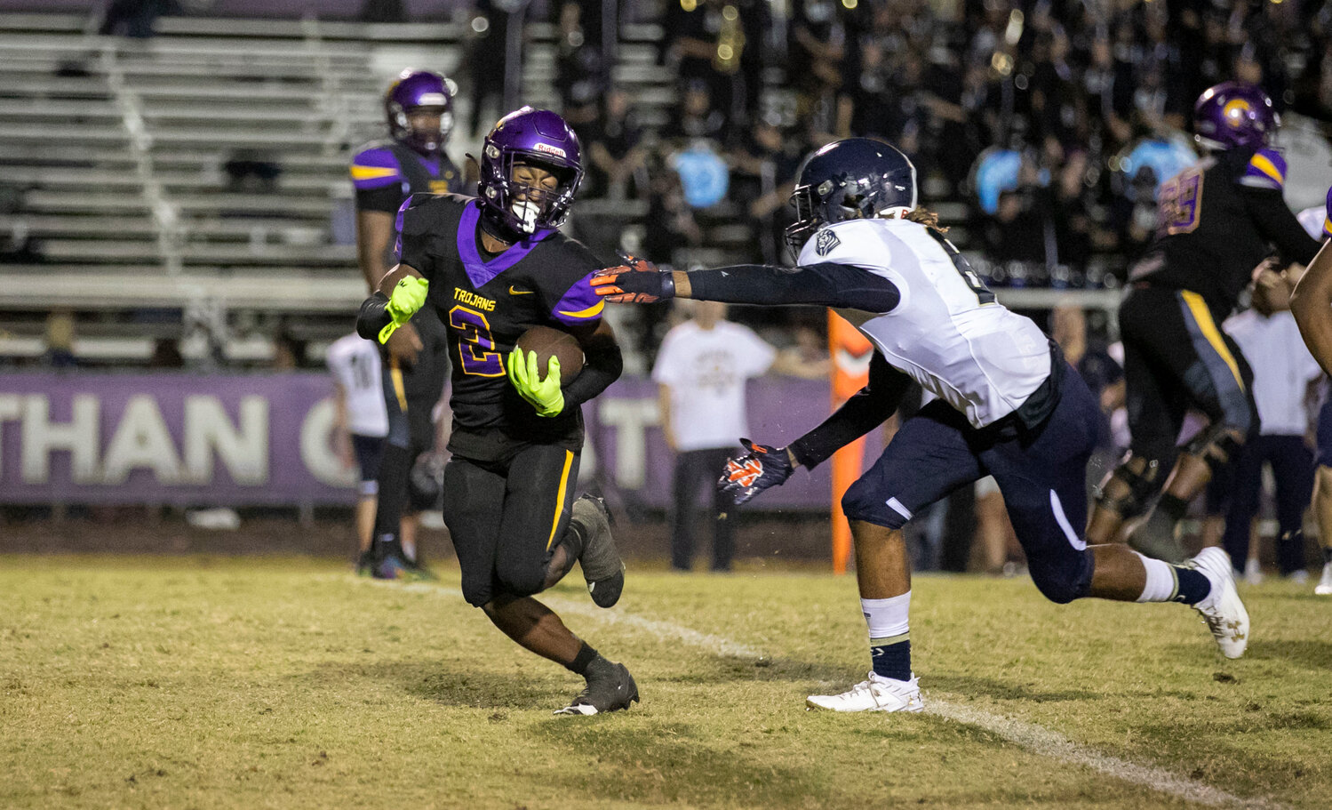 Foley senior Dereon Autrey reaches out to pull down Daphne sophomore Jaecyn Myles behind the line of scrimmage Friday night during the Class 7A Region 1 game between the Lions and Trojans. Autrey provided an interception returned for a touchdown to Foley’s region-finale efforts.