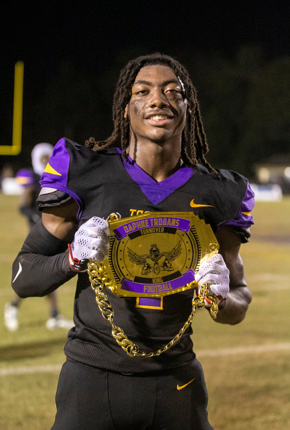 Cayden Williams celebrates a 57-35 win over the Foley Lions with the Daphne Trojans’ turnover belt after he supplied a pick-six to the defensive efforts that helped shut down an explosive offense. Williams’ assignment was to cover Foley receiver and Auburn commit Perry Thompson man-to-man all game and head coach Kenny King said the linebacker delivered.