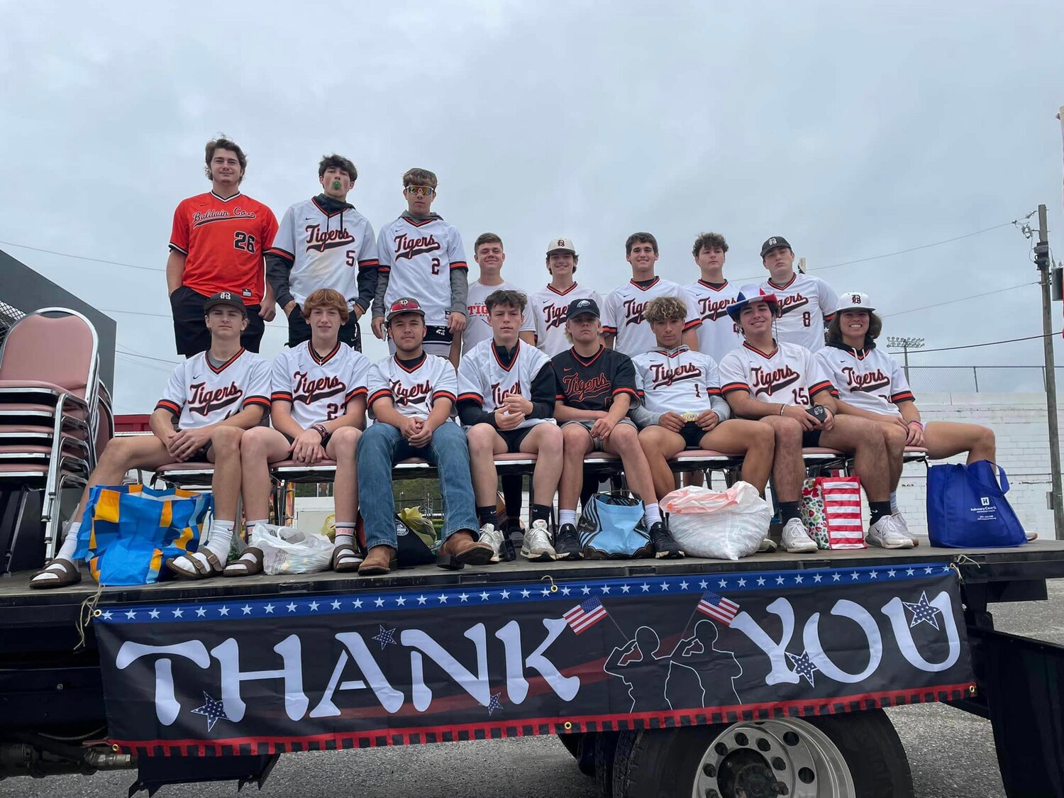 Members of the Baldwin County High School baseball team ride through a Veterans Day parade.