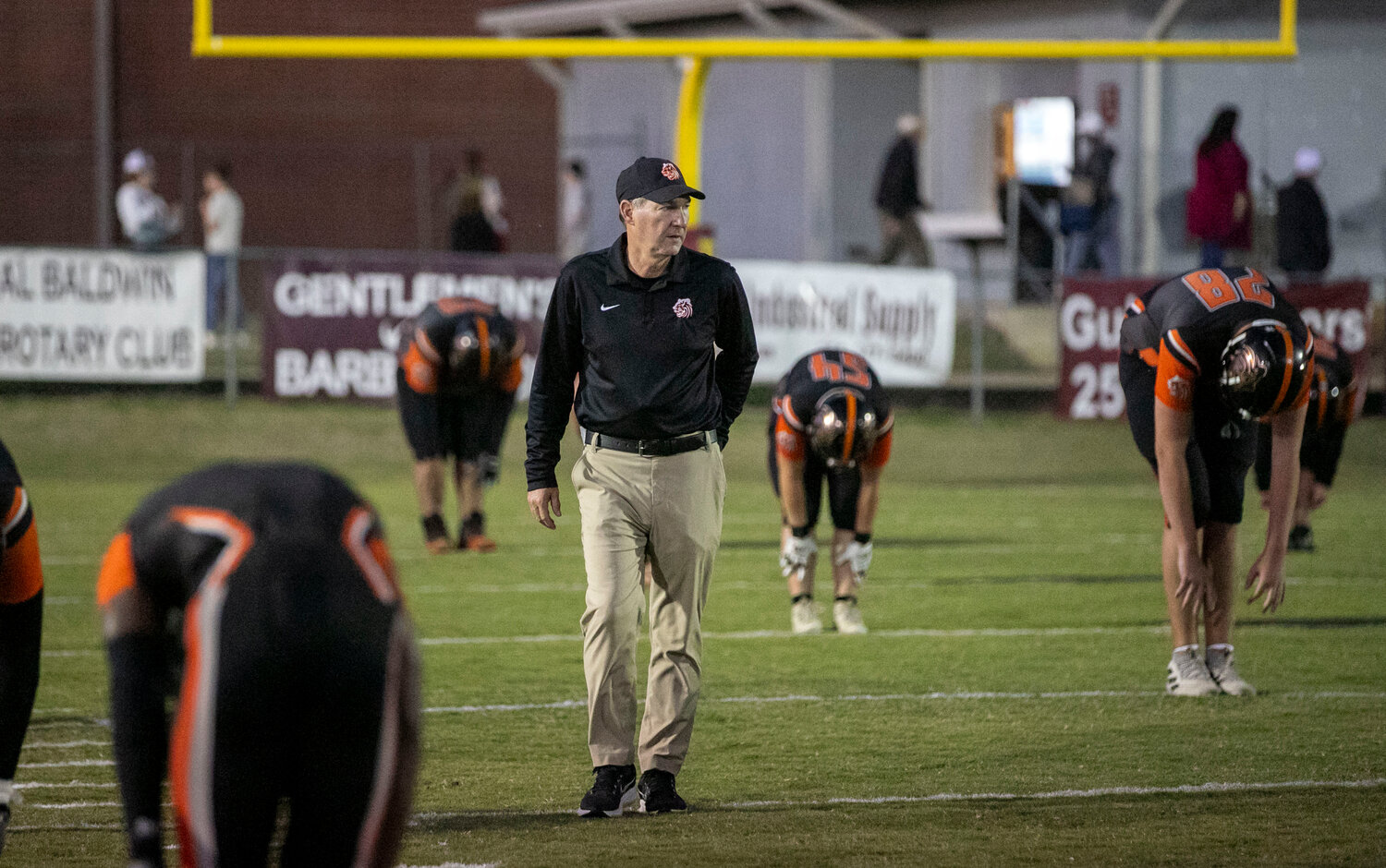 Baldwin County head football coach Scott Rials surveys his team as they warm up for a Class 6A Region 1 away contest against the Robertsdale Golden Bears at JD Sellars Stadium on Nov. 3. Although the Tigers earned a 43-13 win to close the season, Baldwin County finished 2-8 overall and relieved Rials of his head coaching duties.