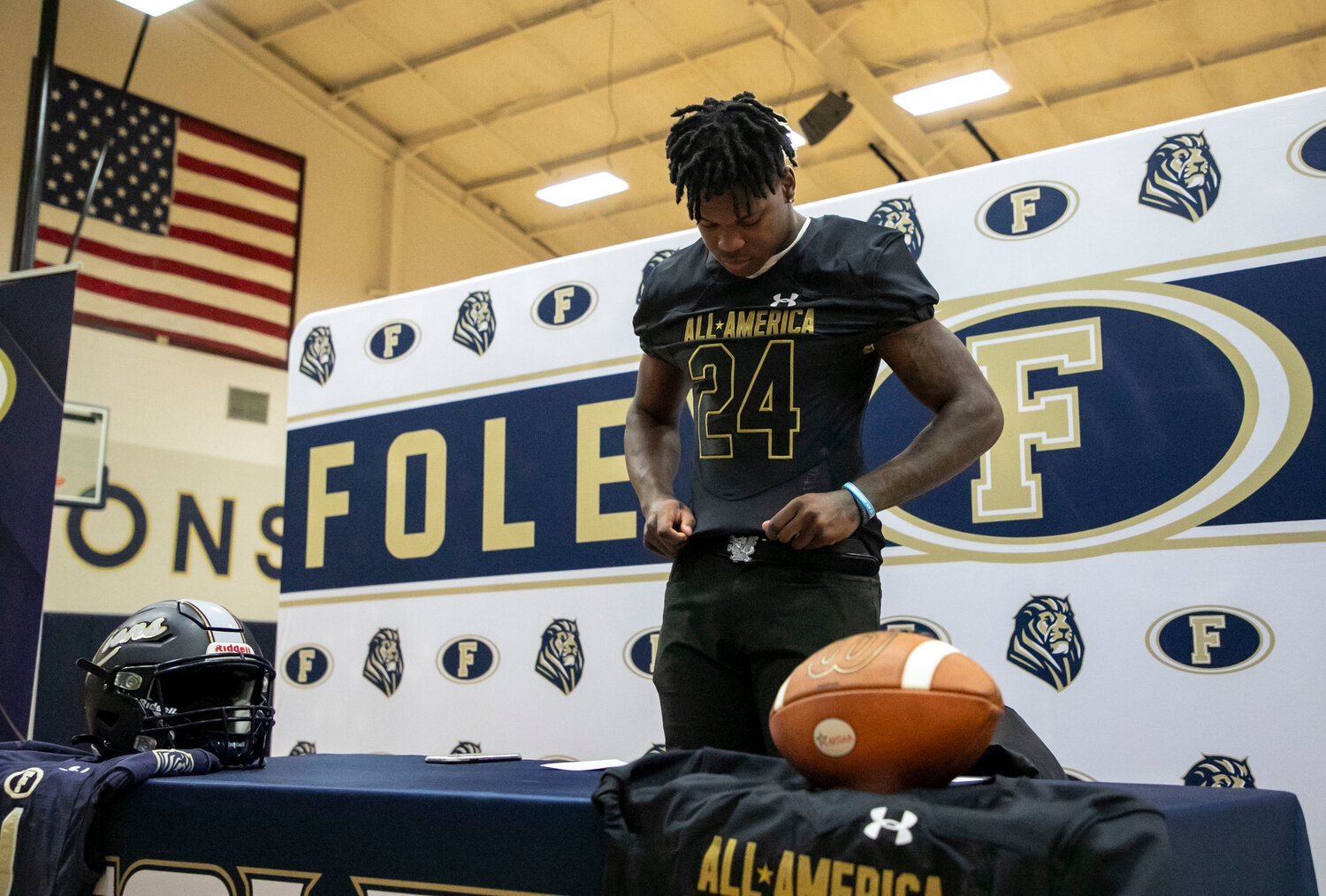 Foley senior Perry Thompson pulls on his new threads that will be displayed at the Under Armour All-America Game in Orlando, Florida, on Jan. 3, 2024. The Auburn commit was recognized with a ceremony at the high school on Friday, Nov. 17.