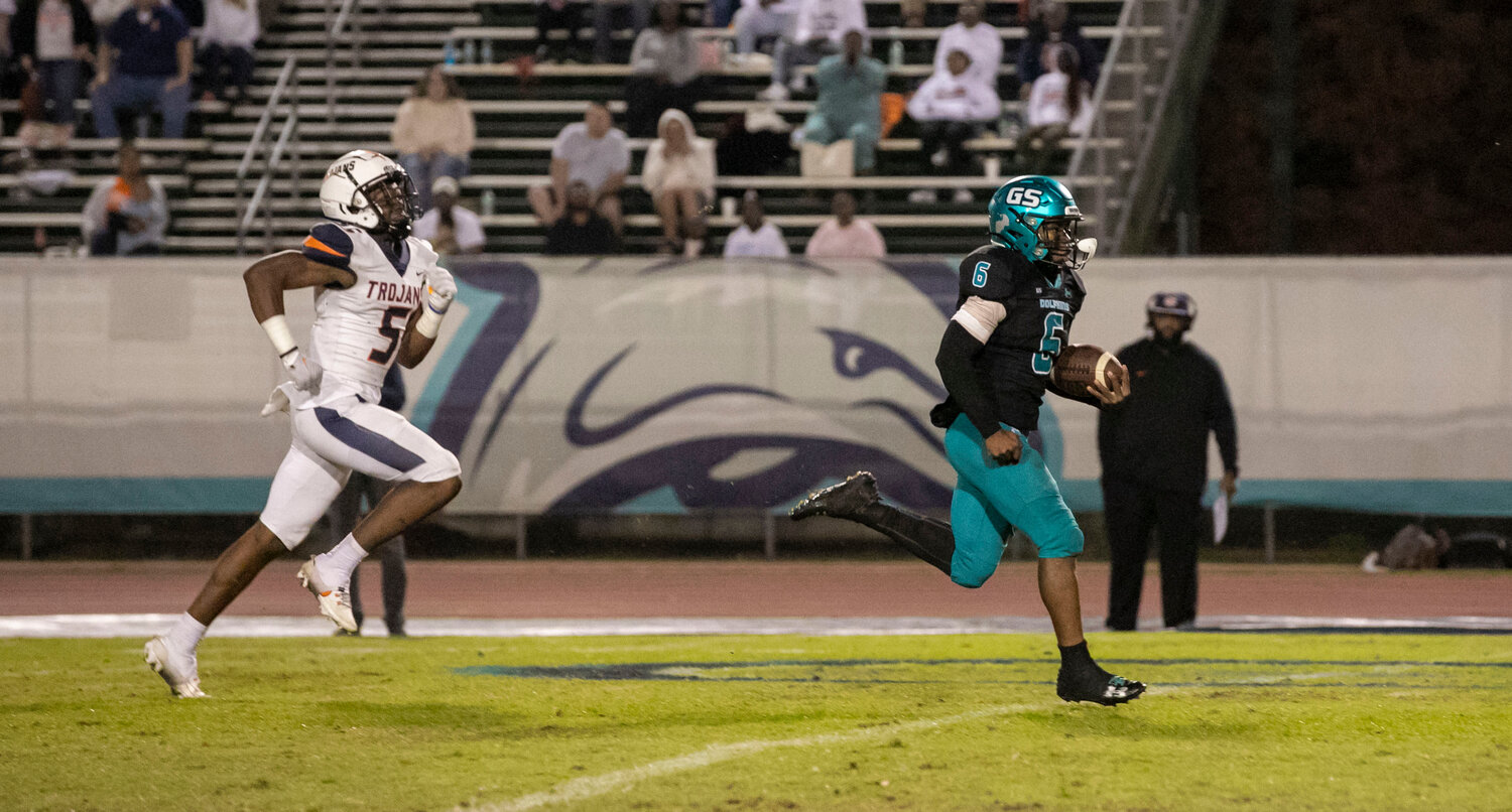 Dolphin sophomore Kolin Wilson hits the open field on his 64-yard touchdown rush in the third quarter of playoff action on Friday, Nov. 17, at the Gulf Shores Sportsplex. Wilson eclipsed triple-digit rushing yards for the 10th time this season after he finished with 121 yards.