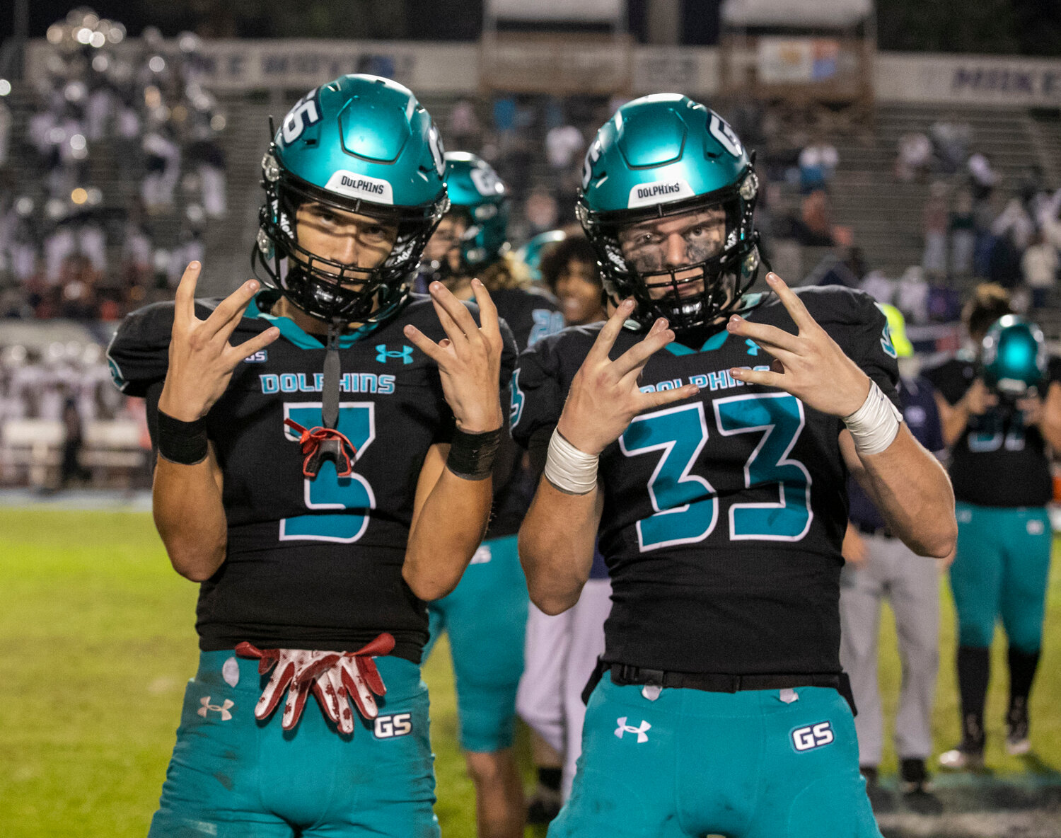 Junior Blaize Thomas (3) and senior Connor Plantz (33) celebrate Gulf Shores’ third-round berth following a 41-0 win over the Charles Henderson Trojans at the Gulf Shores Sportsplex Friday night. The Dolphins advance to their second consecutive state quarterfinal where the Headland Rams will host next week’s third-round tilt.