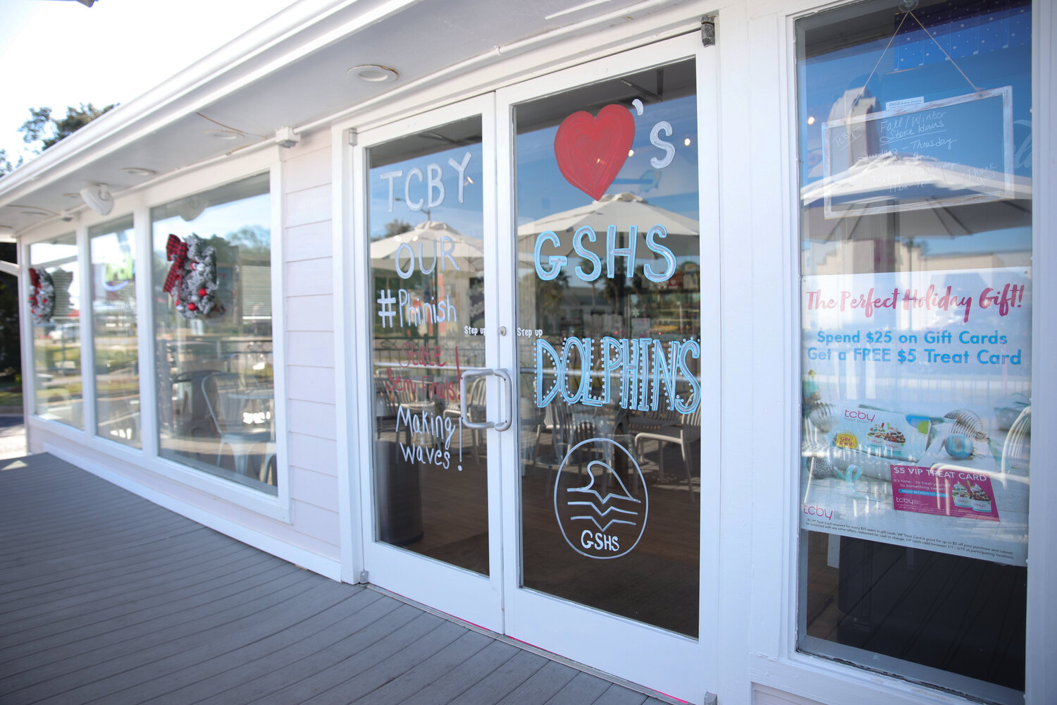 TCBY Gulf Shores shows their support to the GSHS football team and their accomplishments by painting "TCBY loves our GSHS Dolphins," on the front entrance.