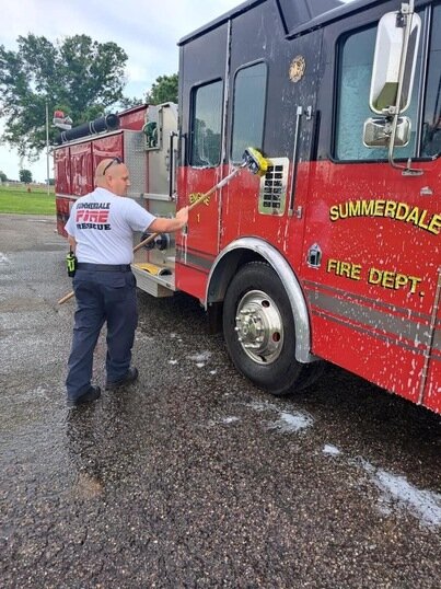 Michael Aaron cleaning a Summerdale fire truck. Since becoming the Summerdale Fire Chief, Aaron created a list of goals he hopes to meet. “My immediate goal, as one of the fastest-growing towns in the state of Alabama, is to find funding sources to help us grow as the community is rapidly growing,” he said. “We are in need of newer apparatus and equipment to be able to provide the needed services that the community expects.”