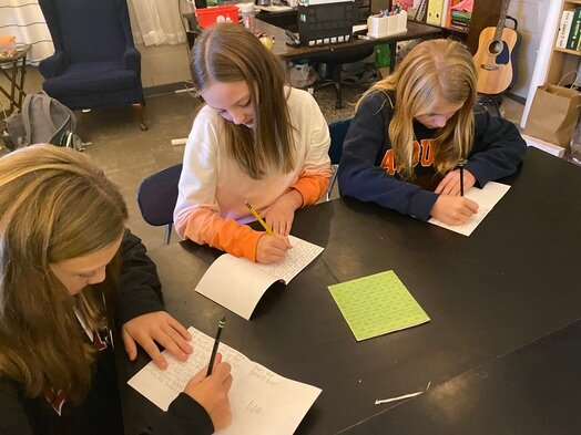 Three of Corbitt's students; Madison Willis, Marley Pierce and Emma Franks, write letters to a teacher or staff member who they are thankful for.