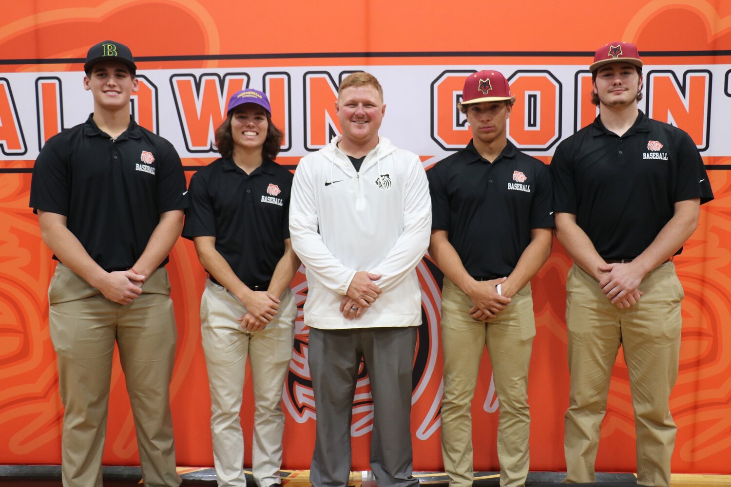 Tiger head baseball coach Trenton Higginbothem joined Wednesday’s honorees in celebrating their college signings. Jaxon Schuler is headed to Bishop State, Landon Walker signed with Montevallo and Quincy Walters and Eli Woody inked commitments to Coastal Alabama.