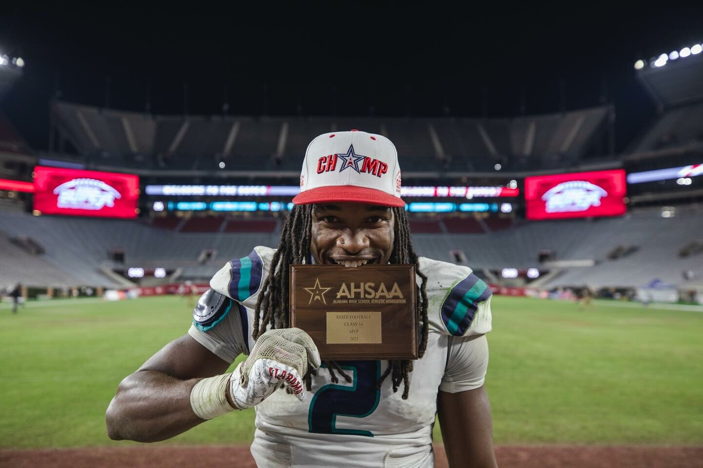 Senior and NC State commit Ronnie Royal celebrates with his MVP plaque after 245 all-purpose yards with two rushing touchdowns, four tackles and a one-handed interception helped Gulf Shores take down Ramsay 21-14 Thursday night. Royal will represent the Dolphins later this month at the AHSAA North-South All-Star Game.