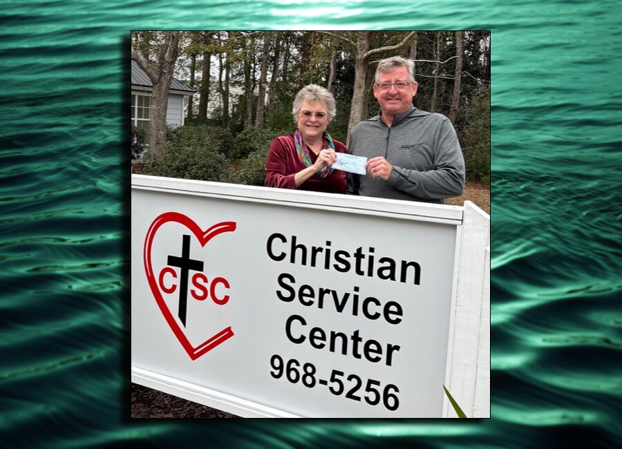 CSC Director Linda Chappelle, left, received a check from Mark Tampary, right.
