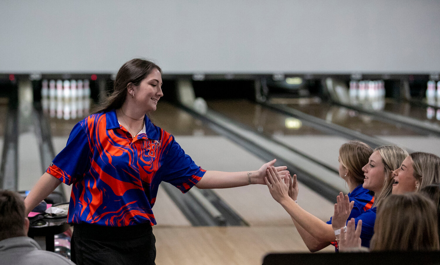 Raeliegh Boesel is greeted by her Orange Beach Mako teammates after her turn during the traditional rounds on Thursday, Feb. 1, at Bowlero Mobile as part of the AHSAA Class 1A-5A Championship. Boesel and the Makos will enter Friday’s finals as the No. 7 seed.