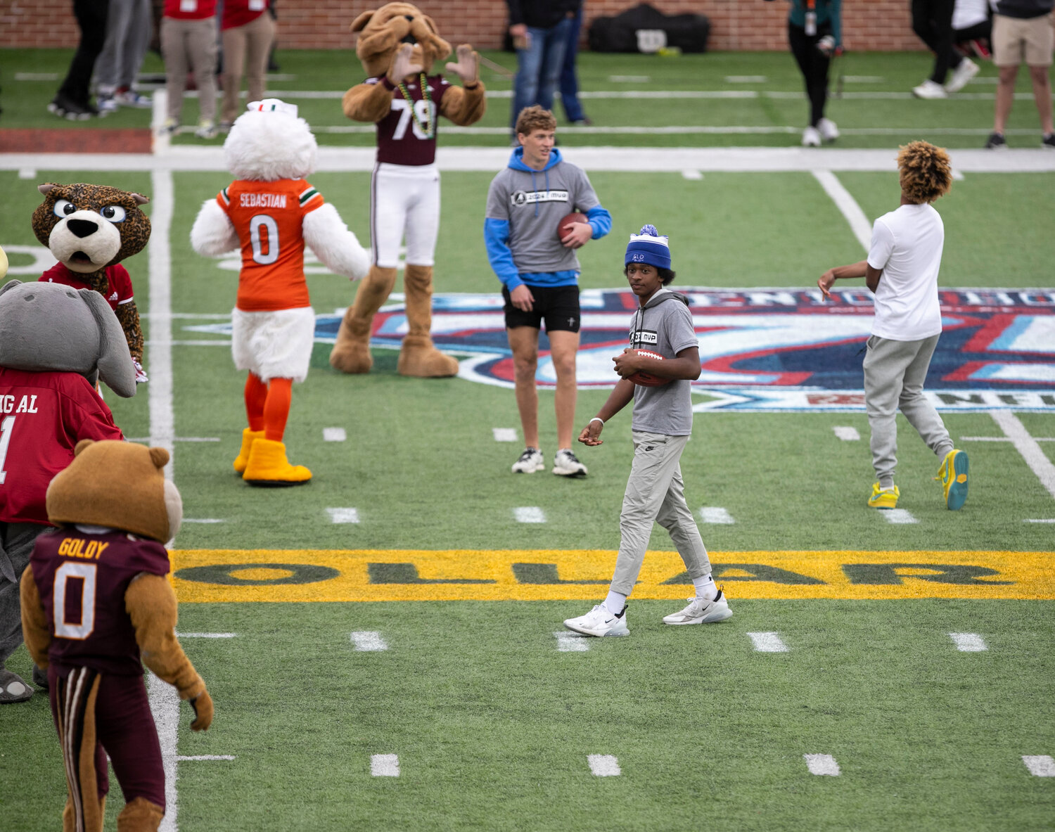 Bayside Academy sophomore Sammy Dunn (beanie) won the Class of 2026 MVP at QB Country’s Senior Bowl high school camp and got the chance to compete in an on-field throwing competition with college football mascots during an intermission of Saturday’s Senior Bowl contest at Hancock Whitney Stadium in Mobile. Although Dunn delivered an accurate ball to the UNC Tar Heel, the pass fell incomplete.