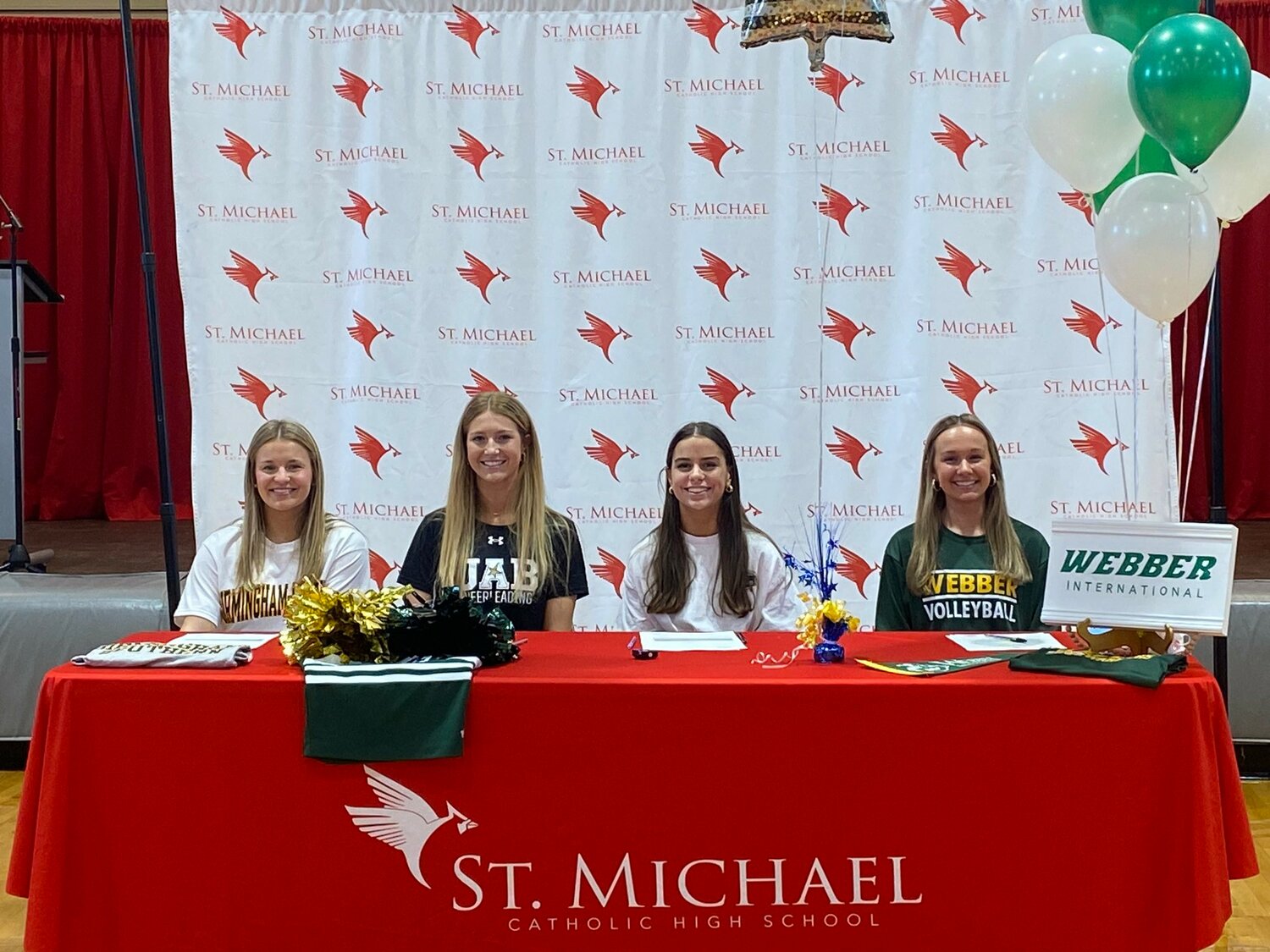 With National Girls and Women in Sports also falling on National Signing Day, four St. Michael Cardinals signed their college commitments during a Feb. 7 ceremony. Pictured from the left are Tatum Hoffman (Birmingham Southern soccer), Landry Mavar (UAB cheerleading), Lizzy Stroud (Southern Union soccer) and Bryanna Marks-Craig (Webber volleyball).