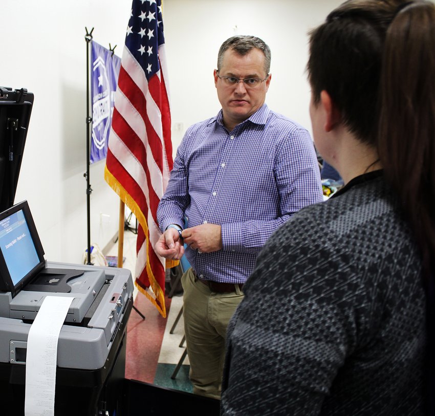 Chris Davis, WilCo's elections administrator, demonstrates the county's new voting machines back when in-person voting didn't seem so fraught.