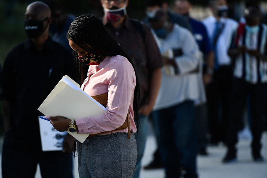 People wear face masks as they wait in line to attend a job fair for employment with SoFi Stadium and Los Angeles International Airport employers, at SoFi Stadium on September 9, 2021, in Inglewood, California. (Patrick T. Fallon/AFP via Getty Images/TNS)
