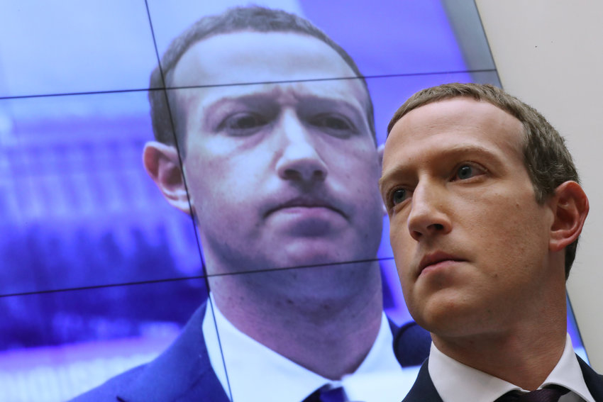 With an image of himself on a screen in the background, Facebook co-founder and CEO Mark Zuckerberg testifies before the House Financial Services Committee on Capitol Hill in 2019. (Chip Somodevilla/Getty Images/TNS)