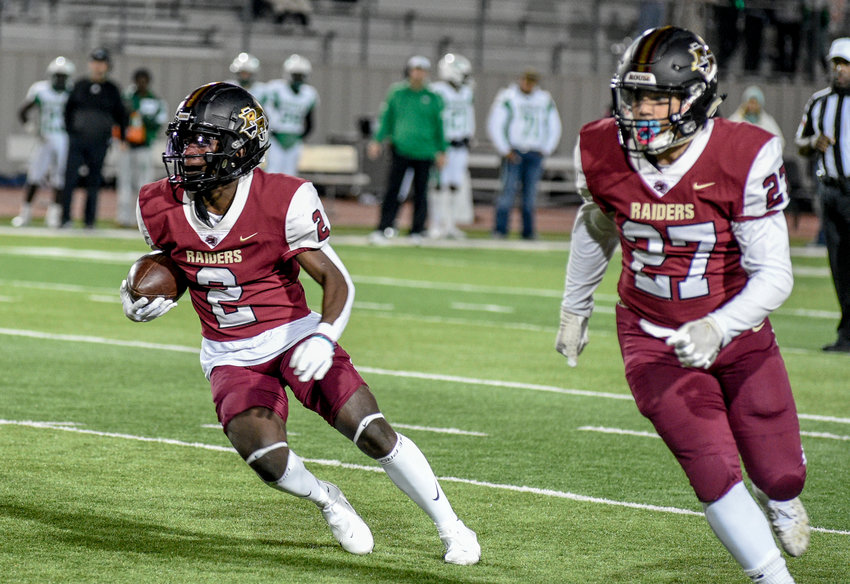 Troy Oliver, left, and Rouse scored 31 points in the second half on Friday night to rally for a 31-24 win over Brenham and win their second straight district title.