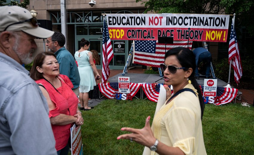 People talk before the start of a rally against &quot;critical race theory&quot; being taught in schools at the Loudoun County Government center in Leesburg, Virginia, in June. Some parents in Texas who say they are concerned about &quot;critical race theory&quot; have successfully petitioned their local school districts to remove certain books from their libraries. (Andrew Caballero-Reynolds/AFP/Getty Images/TNS)