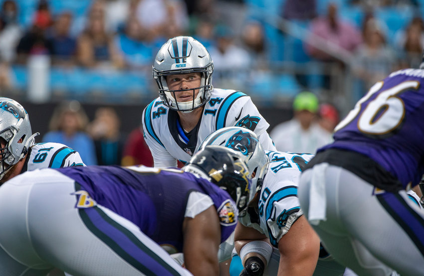 Carolina Panthers quarterback Sam Darnold (14) under center against the Baltimore Ravens during the first half of a preseason game at Bank of America Stadium on Saturday, Aug. 21, 2021, in Charlotte, North Carolina. (Chris Keane/Getty Images/TNS)