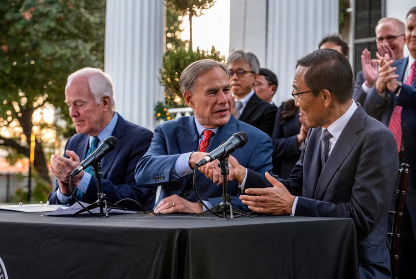 Greg Abbott shakes hands with Samsung CEO and Vice Chairman Ki Nam Kim at an economic announcement at the Texas Governor's Mansion on Nov. 23, 2021, in Austin. Greg Abbott was joined by U.S. Sen. John Cornyn, R-Texas, and Samsung CEO and Vice Chairman Ki Nam Kim to announce a new $17 billion chip plant in Taylor, the third such plant in the area. Credit: Sergio Flores for The Texas Tribune