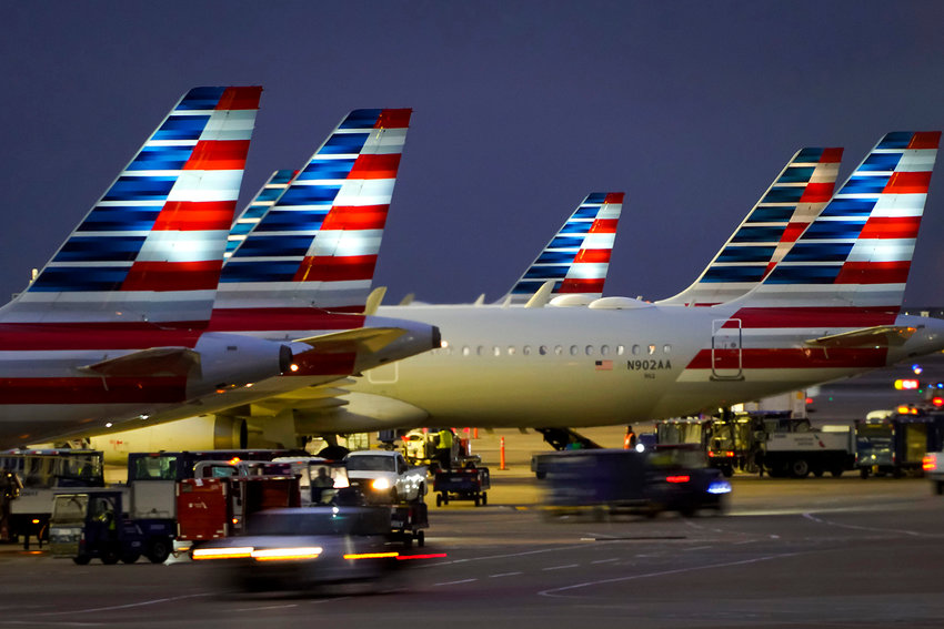 American Airlines planes are seen at the gates of Terminal C at DFW Airport on Friday, Jan. 7, 2022. (Smiley N. Pool/Dallas Morning News/TNS)
