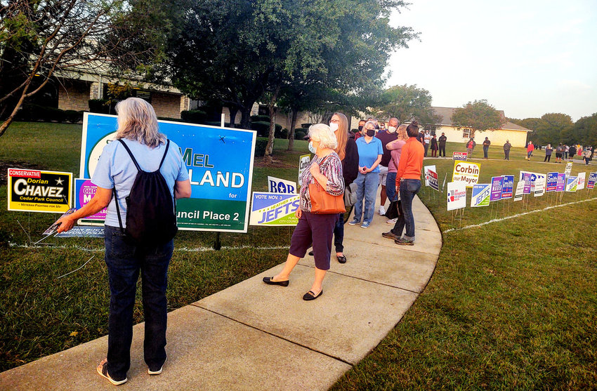 Voters line up to vote early at the Cedar Park Public Library on the first day of early voting in 2020.
