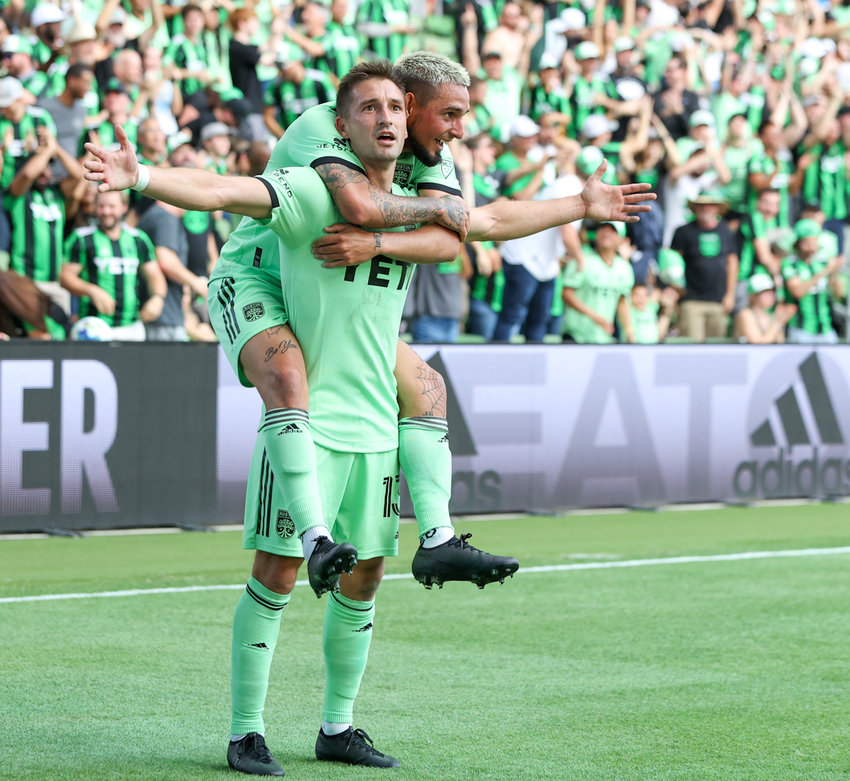 Austin FC midfielder Ethan Finlay (13) celebrates with forward Diego Fagundez (14) after a goal in the second half of a Major League Soccer match against Inter Miami on March 6, 2021 in Austin, Texas.