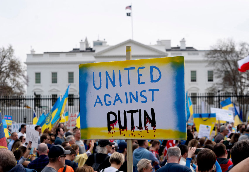 A demonstrator holds a United Against Putin sign outside the White House in Washington, DC, on March 6, 2022, during a rally in support of Ukraine. (Stefani Reynolds/AFP via Getty Images/TNS)