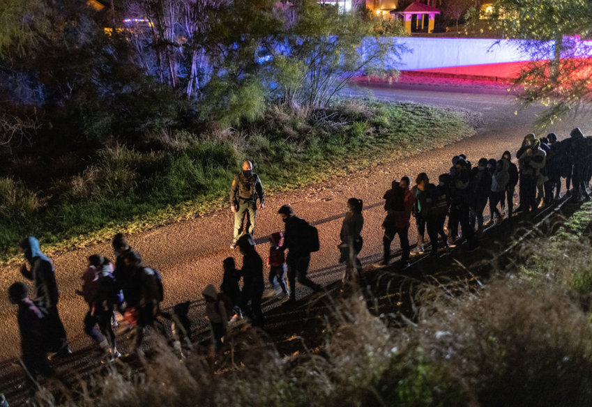 U.S. Border Patrol agents process immigrant families after they crossed the Rio Grande into south Texas on April 30, 2021 in Roma, Texas. (John Moore/Getty Images/TNS)