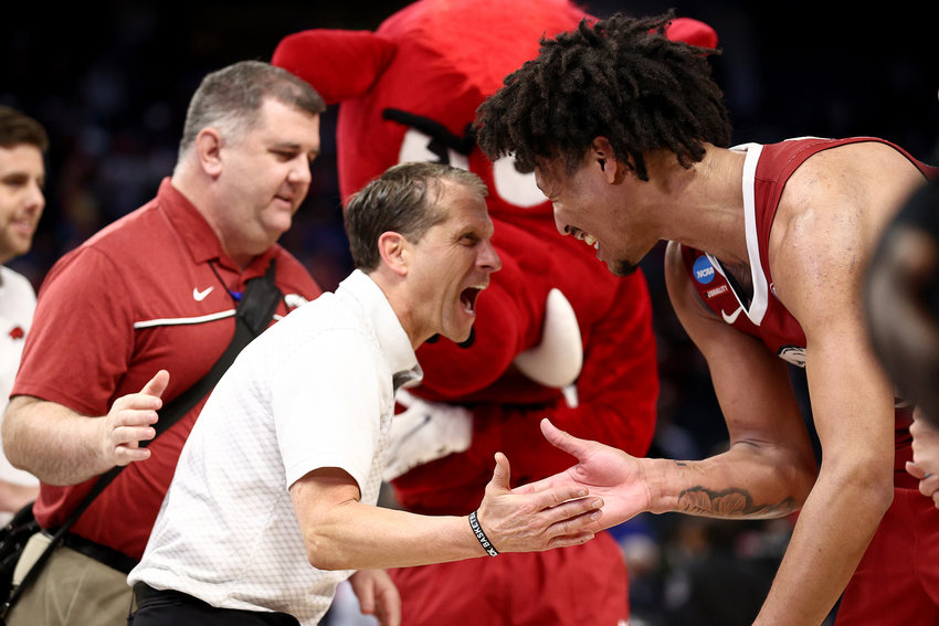 Jaylin Williams (10) of the Arkansas Razorbacks celebrates with head coach Eric Musselman after defeating the Gonzaga Bulldogs 68-74 in the Sweet Sixteen round game of the 2022 NCAA Men's Basketball Tournament at Chase Center on March 24, 2022, in San Francisco, California. (Ezra Shaw/Getty Images/TNS)