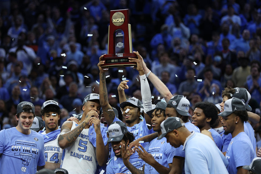 Leaky Black (1) of the North Carolina Tar Heels holds up the trophy after defeating the St. Peter's Peacocks 69-49 in the Elite Eight round game of the 2022 NCAA Men's Basketball Tournament at Wells Fargo Center on March 27, 2022, in Philadelphia. (Patrick Smith/Getty Images/TNS)